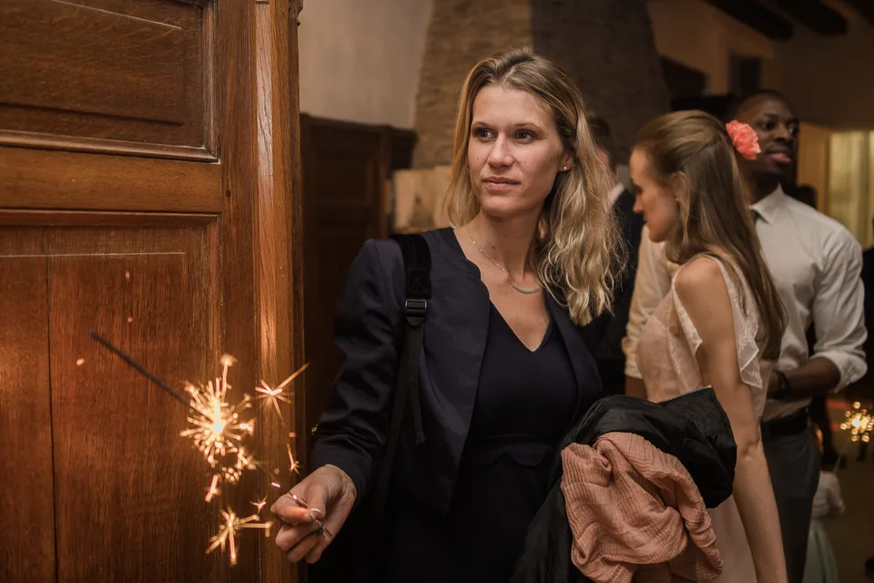 A guest holding a sparkler during the evening