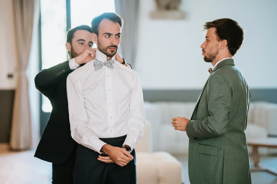 Loved ones helping the groom get ready