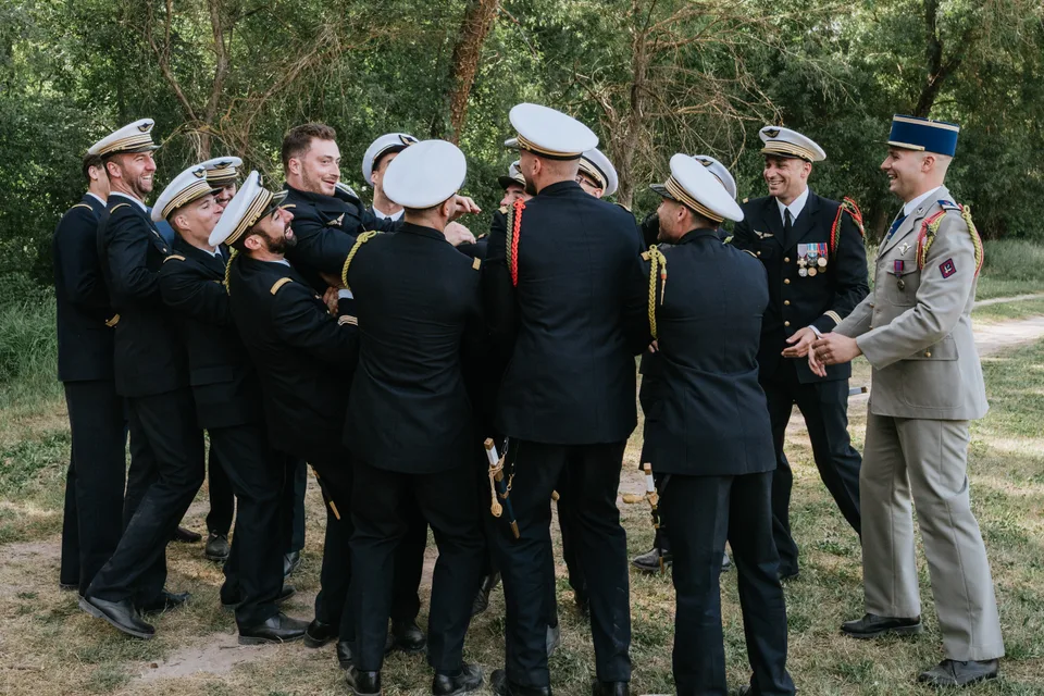 Guests seen from behind with their hats raised