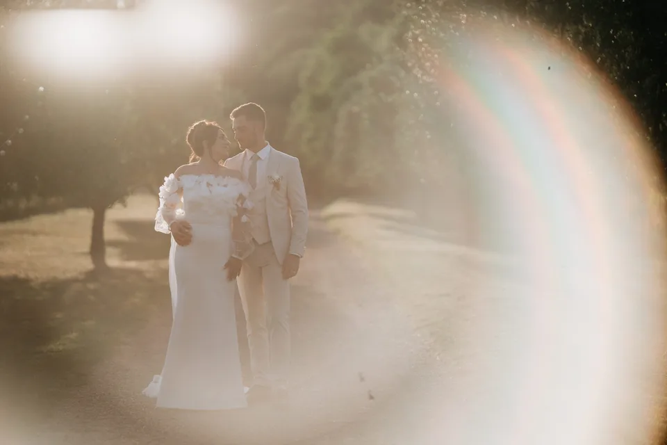 Newlyweds in golden light and a sun flare
