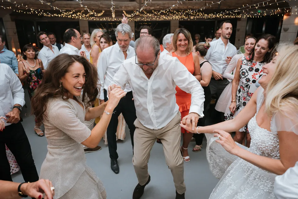 Hands joining around the bride on the dance floor