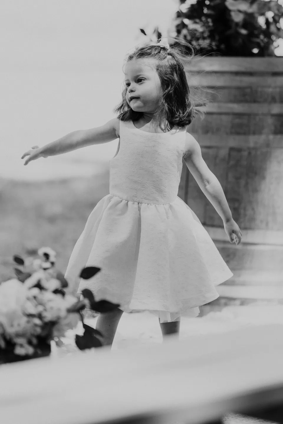 A young guest running in a light dress, in black and white