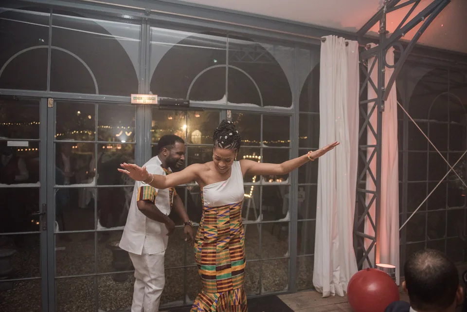 A couple dancing in front of the reception windows