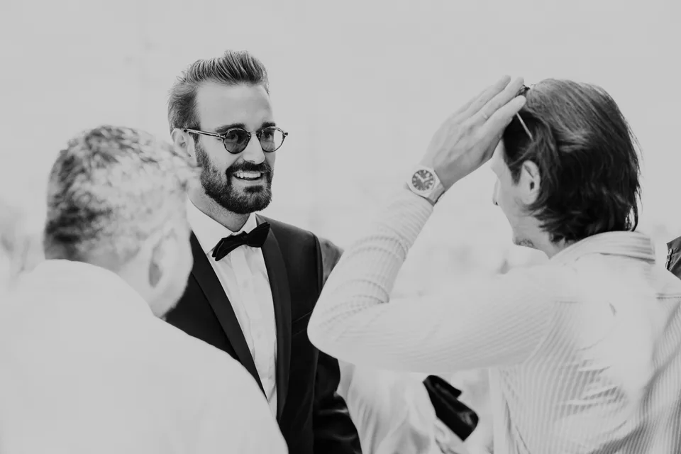 Newlyweds exchanging a smile, in black and white