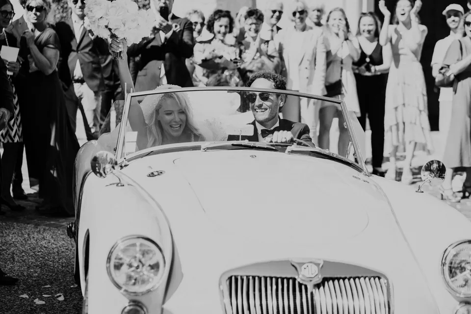 Newlyweds in a vintage car, in black and white