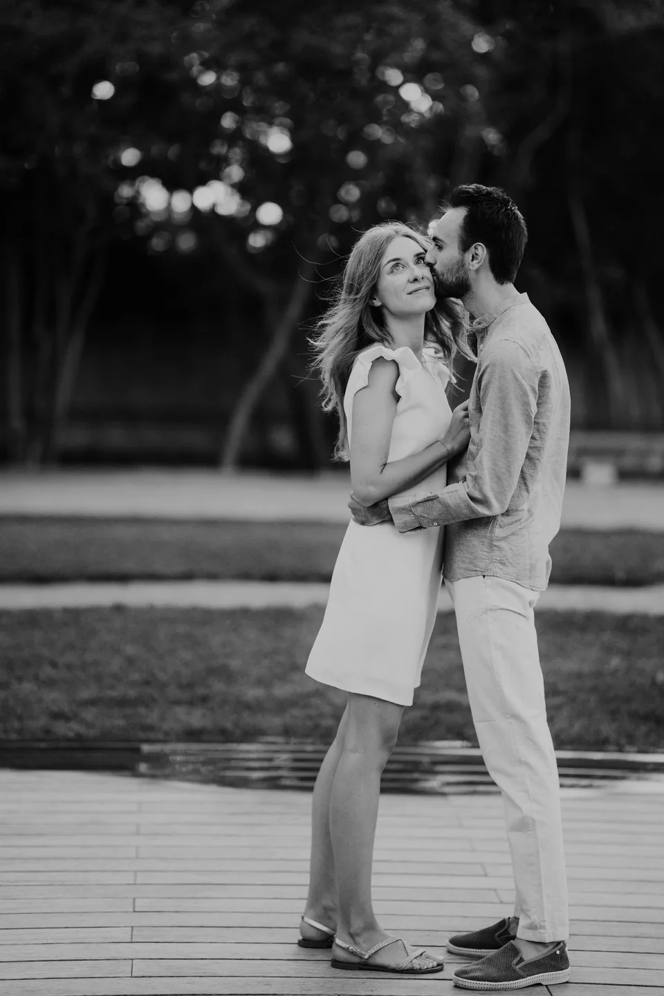 Newlyweds embracing on a path, in black and white