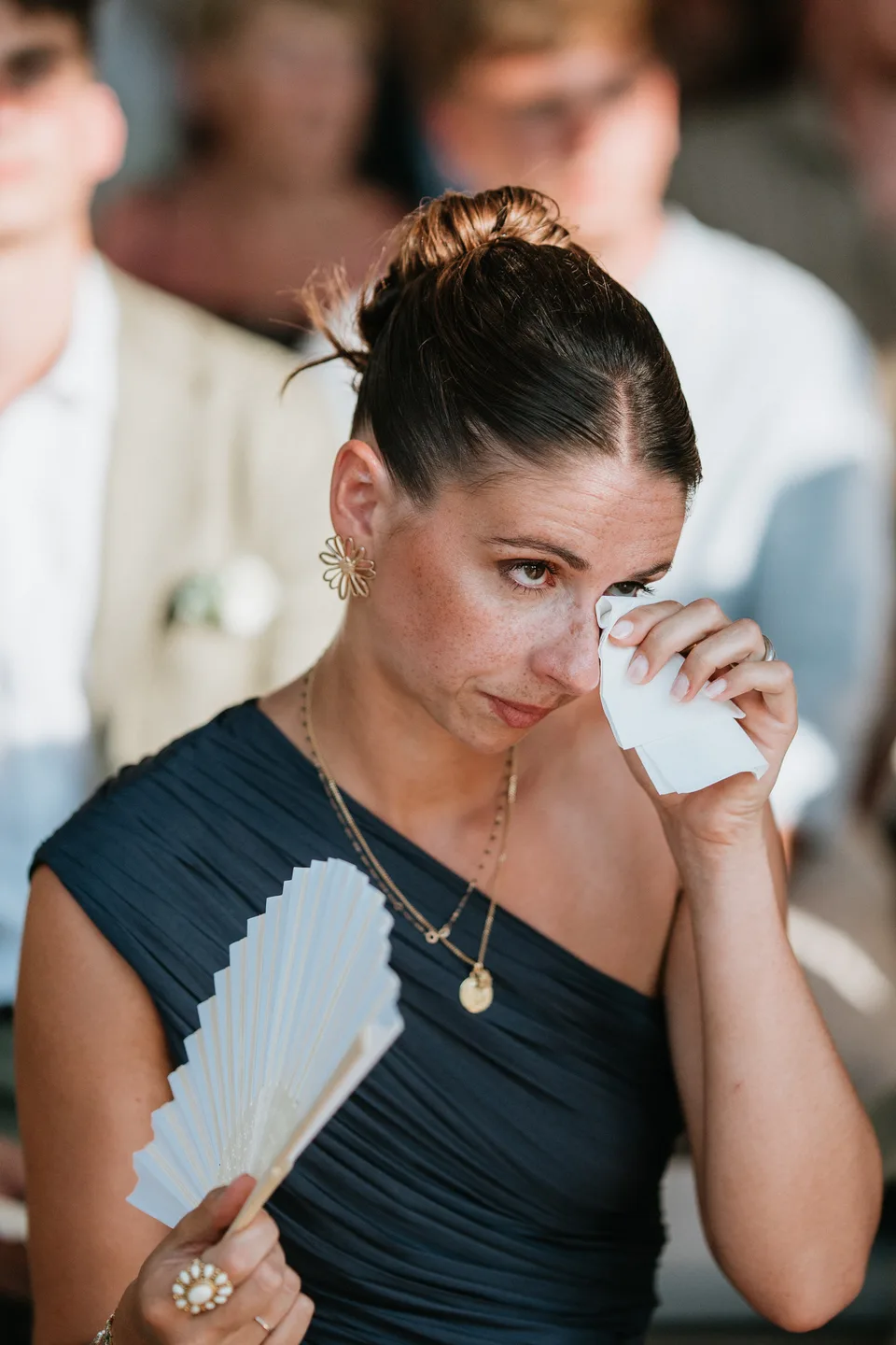 A guest wiping away a tear during a speech