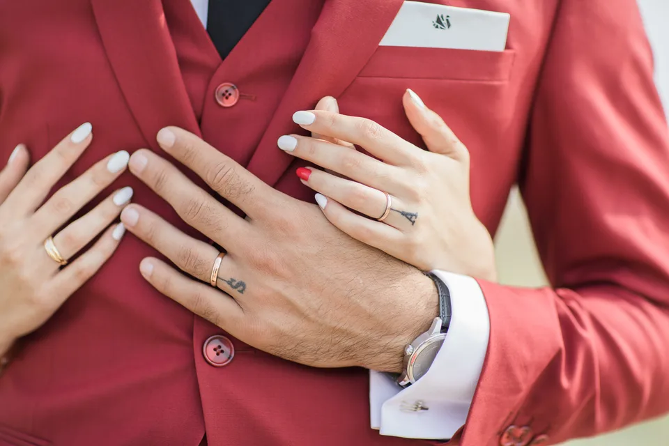 The newlyweds’ intertwined hands and wedding rings