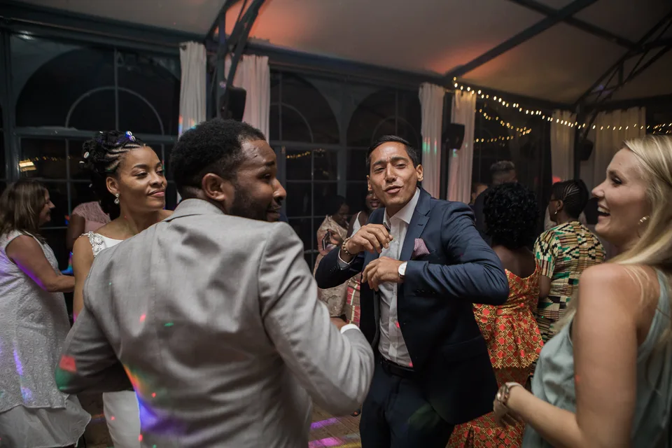 Guests and newlyweds dancing together