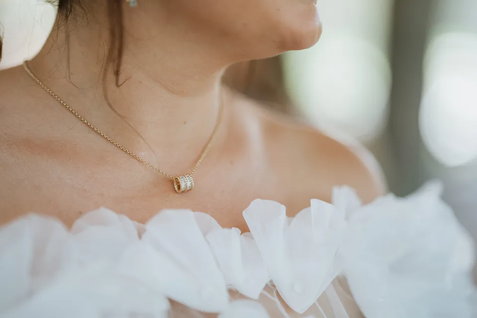 Detail of the bride’s floral neckline and necklace