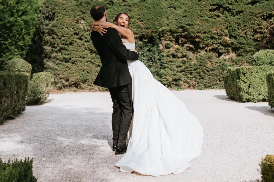 Newlyweds twirling together in the garden