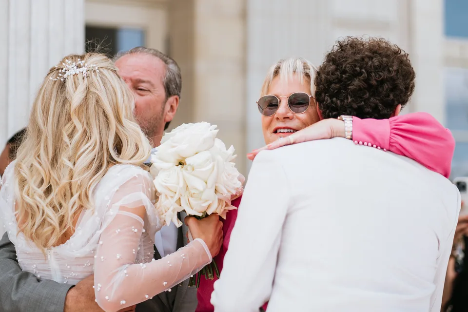 Newlyweds greeting loved ones with kisses