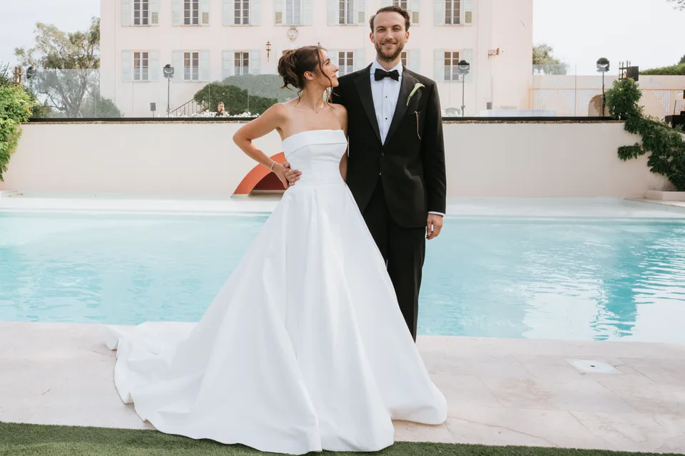 Newlyweds beside a pool