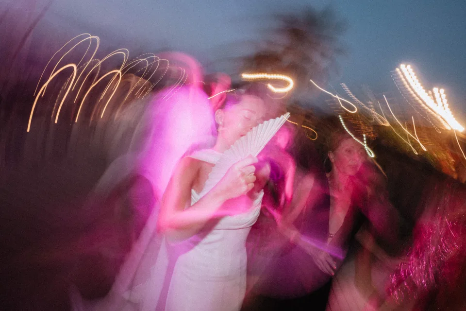 The bride moving through colourful party lights