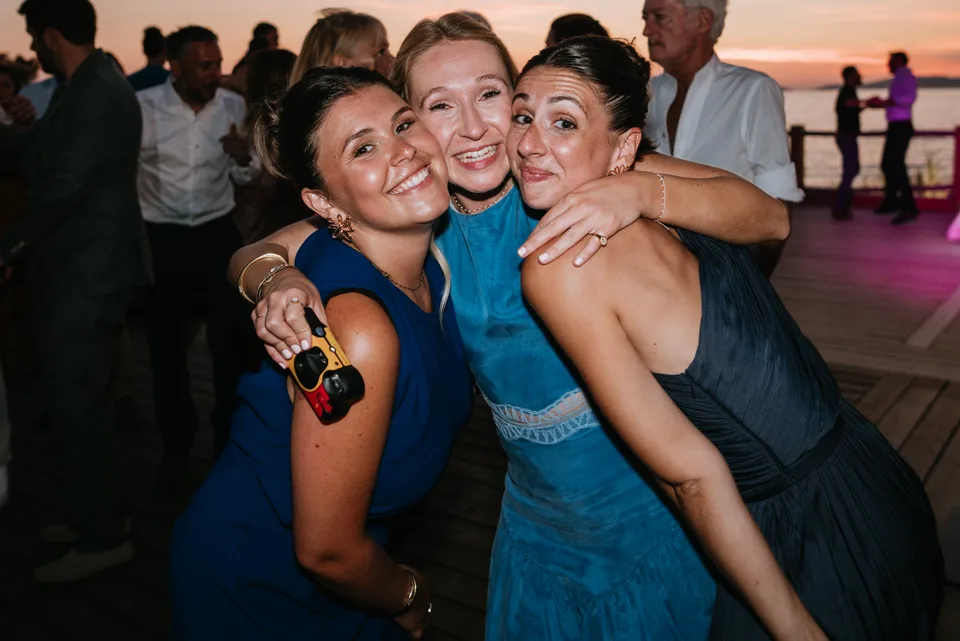 Two guests exchanging a kiss on the cheek at the party