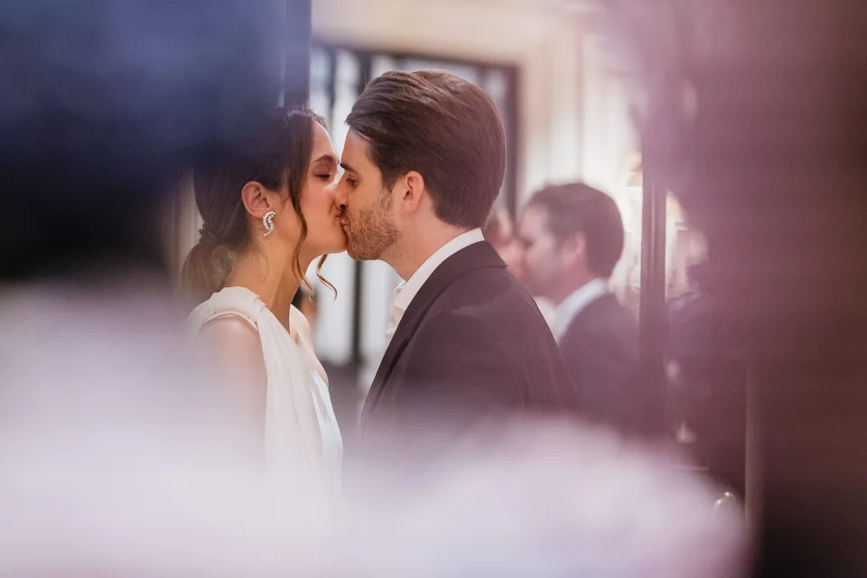 Newlyweds kissing in soft light