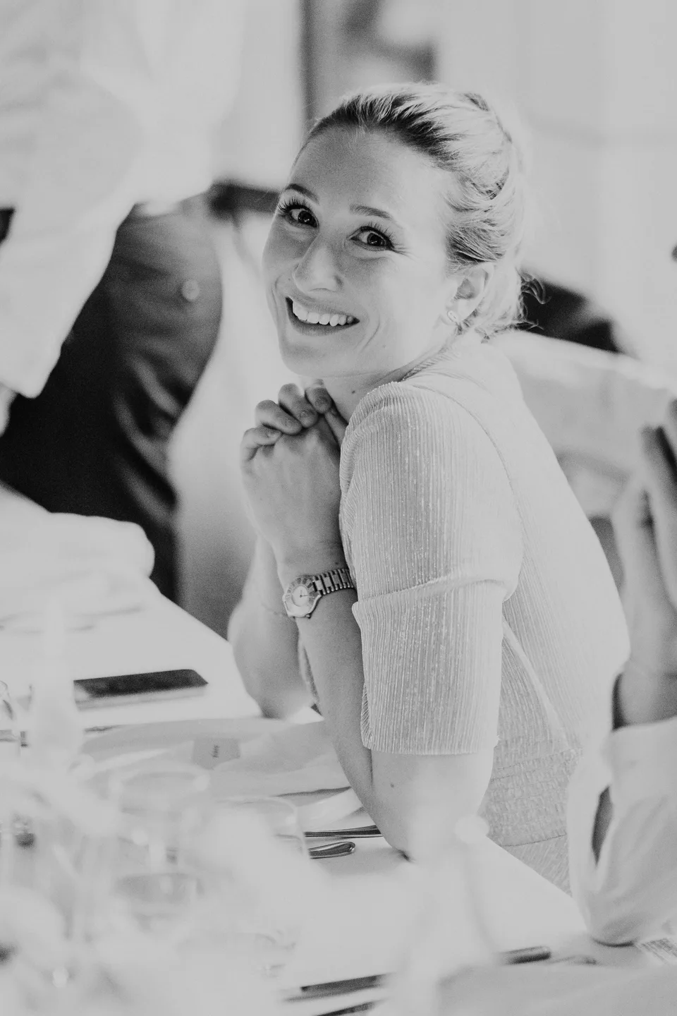 The bride looking back with a smile, in black and white