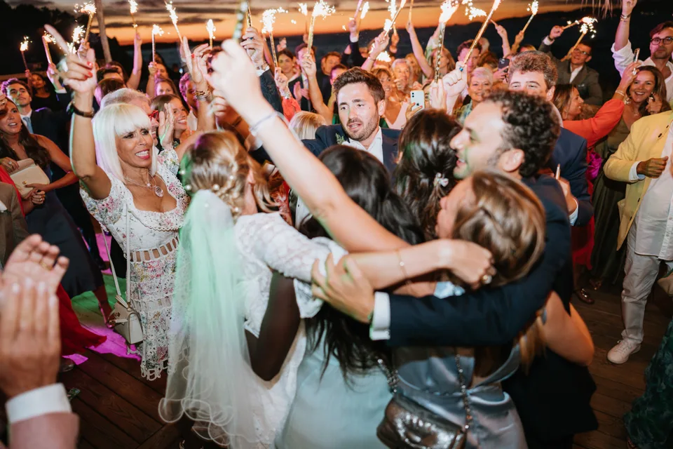 Guests dancing in a circle in the evening light