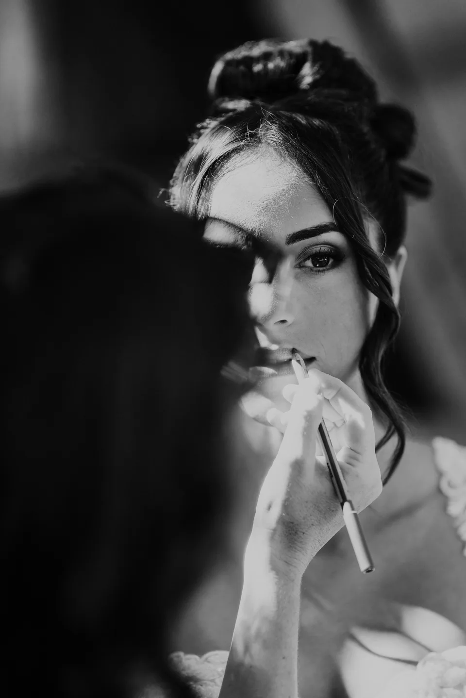 The bride adjusting her veil in black and white