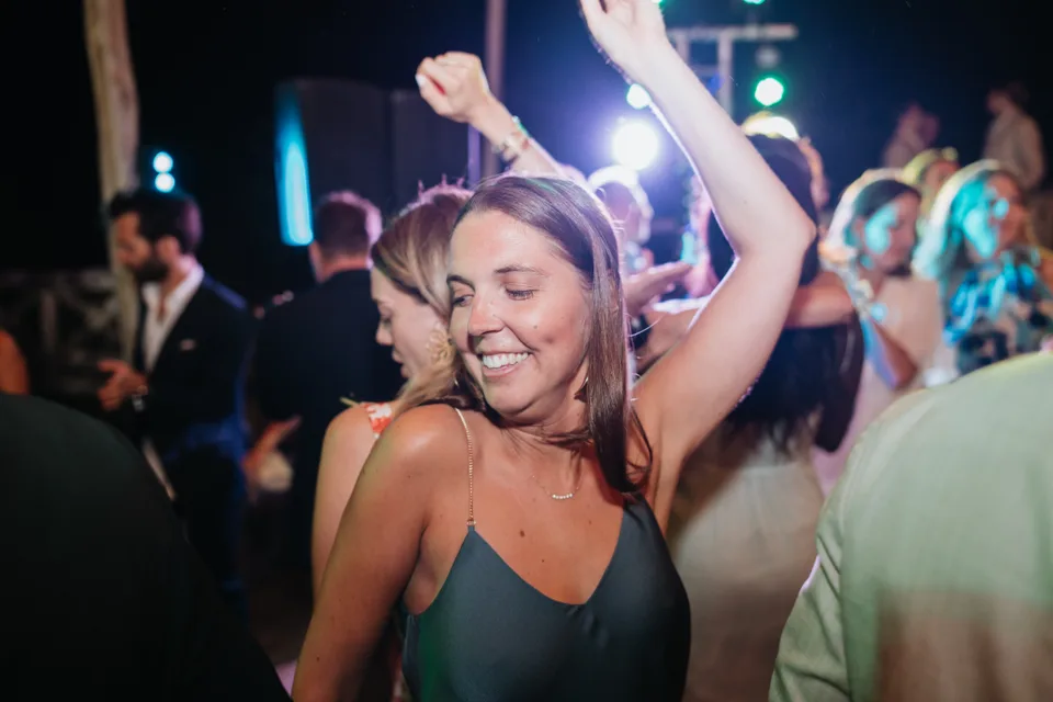 A guest dancing with eyes closed and arms raised