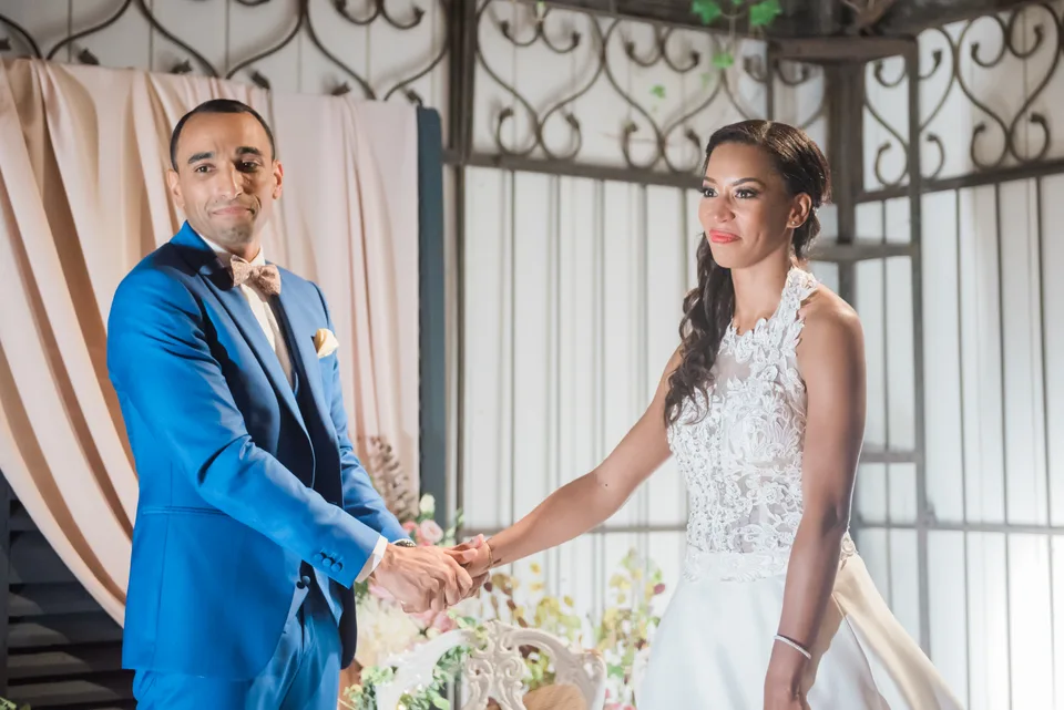 Newlyweds holding hands during the ceremony