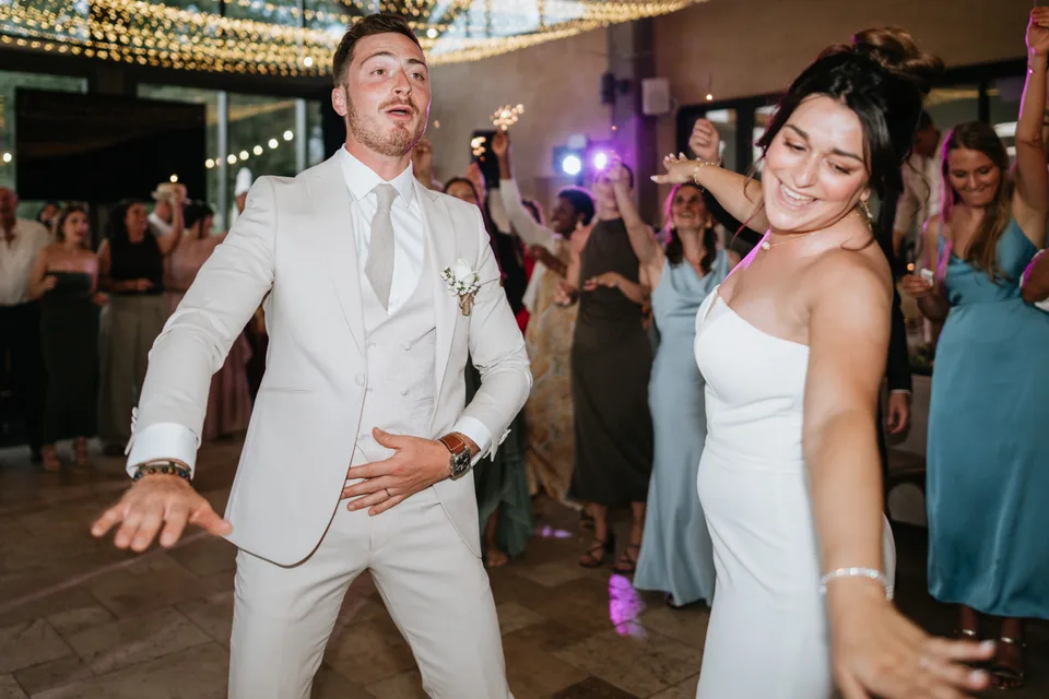 Newlyweds dancing among the guests
