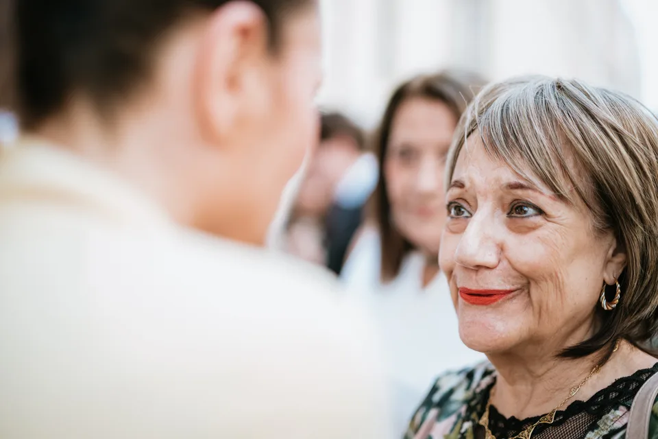 A guest smiling among the conversations
