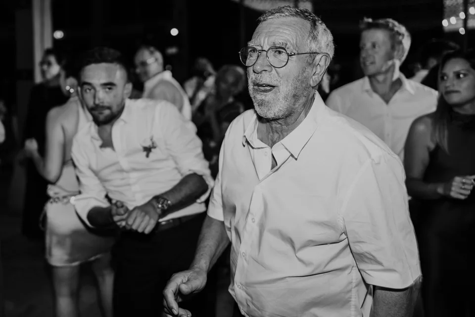 A guest laughing during the party, in black and white