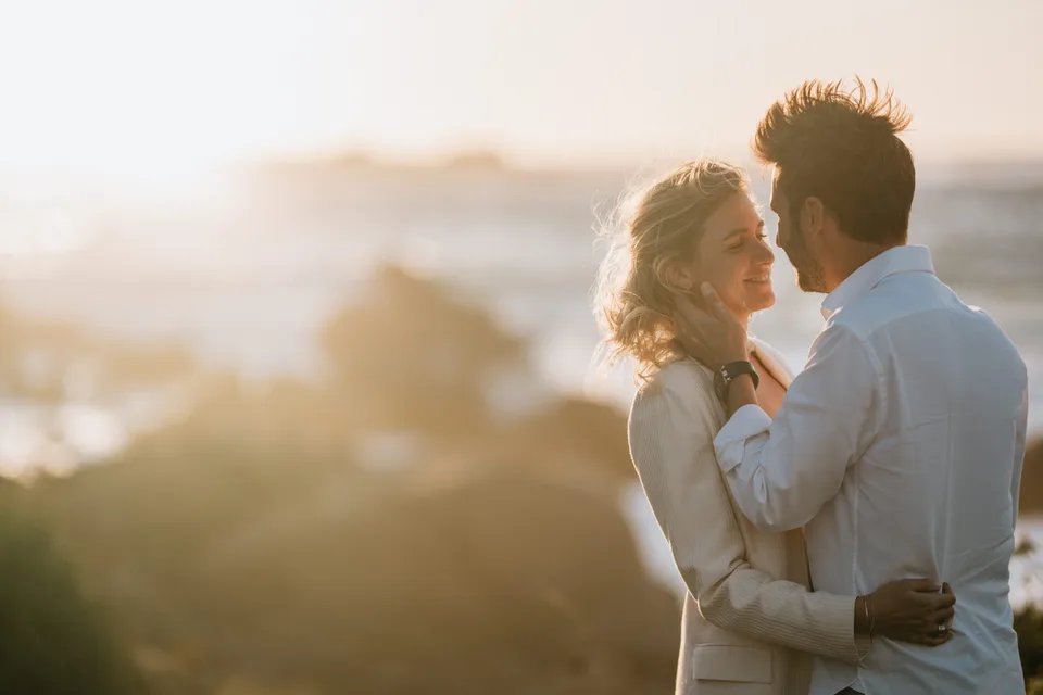 Newlyweds looking at the landscape in evening light
