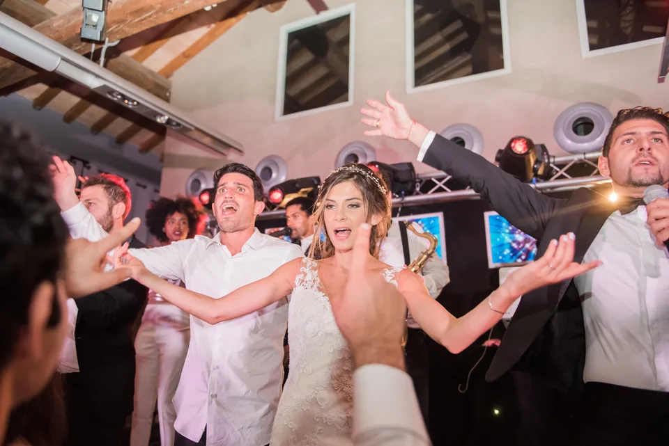 Guests dancing around the bride