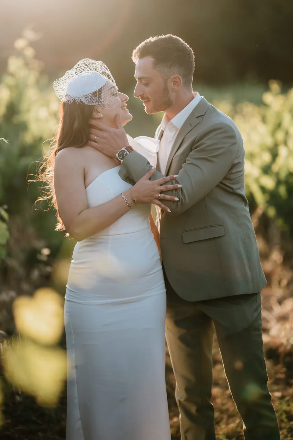 Newlyweds together in backlit grasses