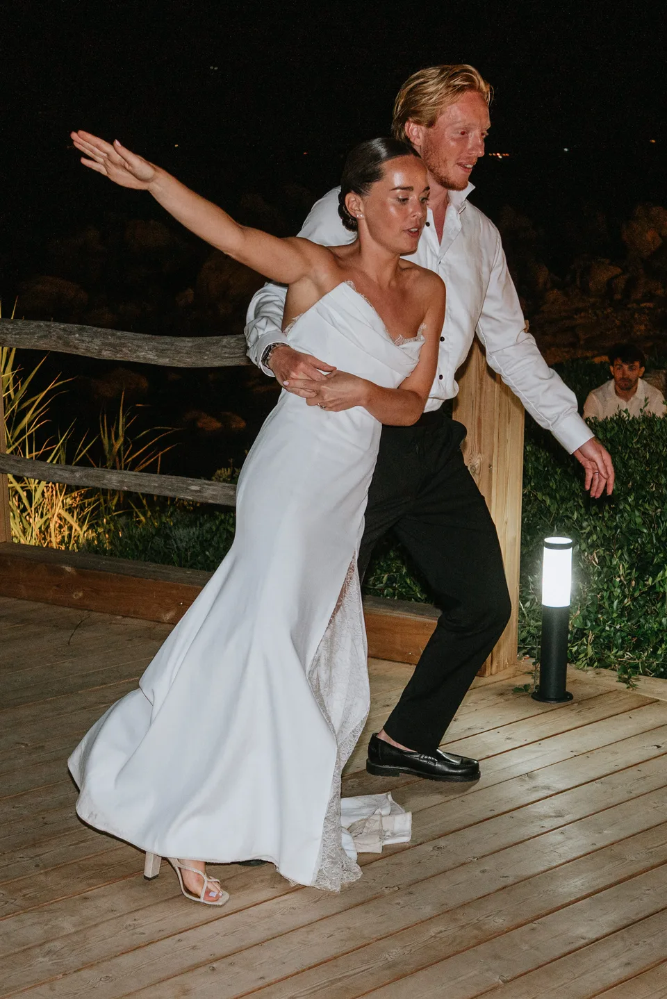 Newlyweds dancing together at night