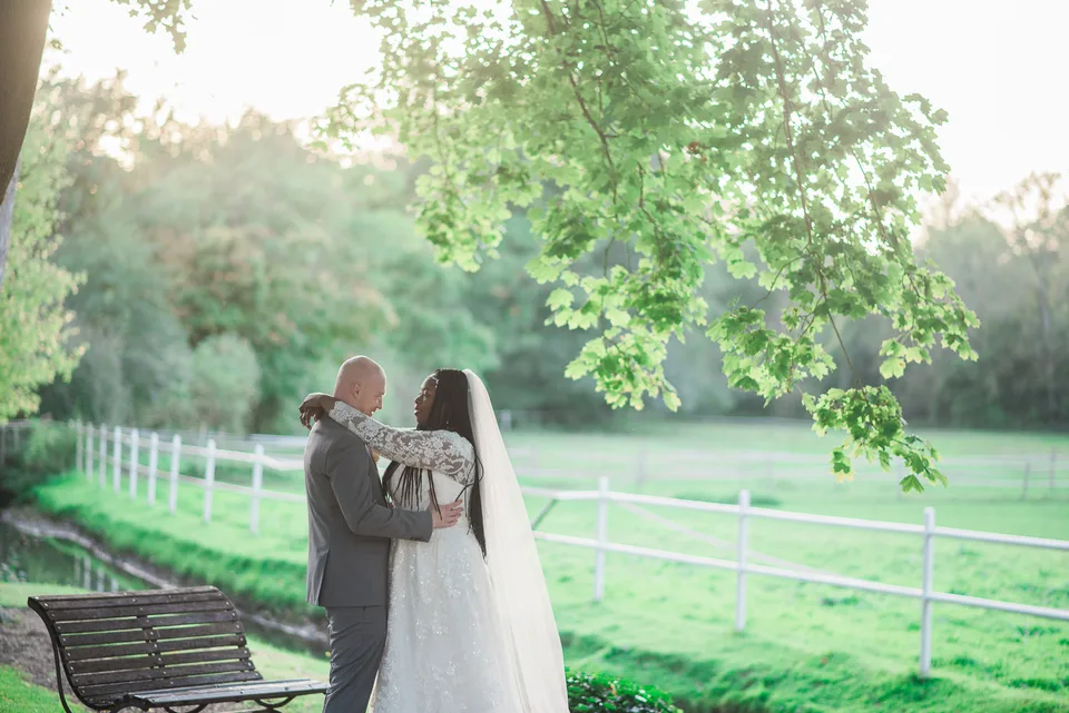 Newlyweds beside the water in evening light