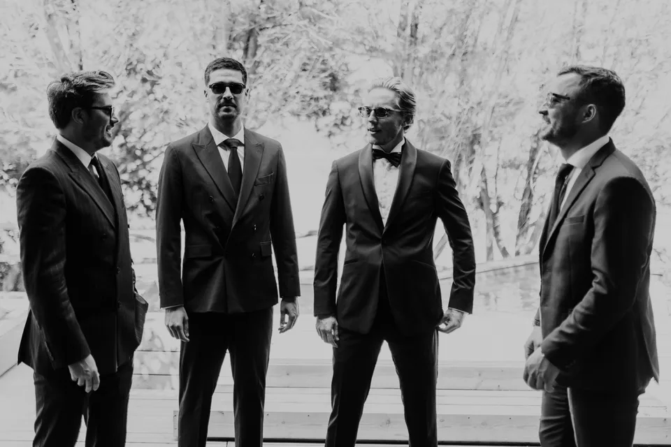 A group of guests in suits, in black and white