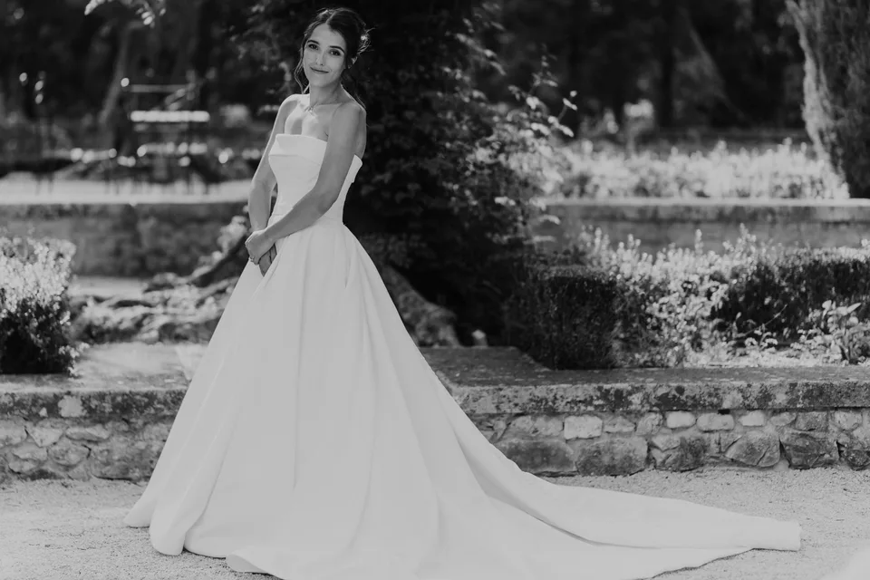 The bride by stone steps, in black and white
