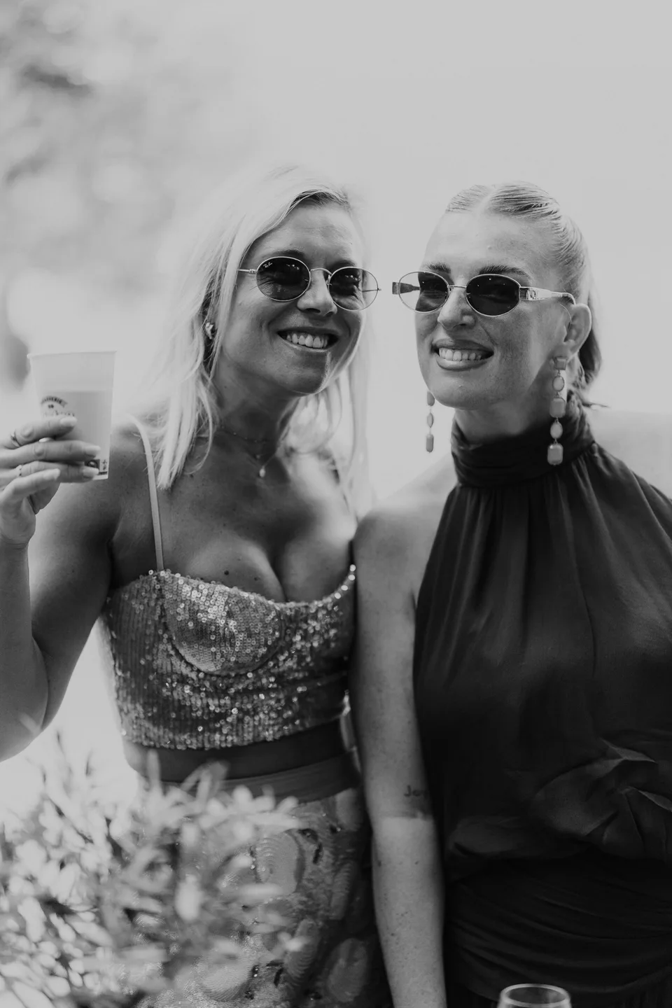 Two guests sharing a smile in black and white