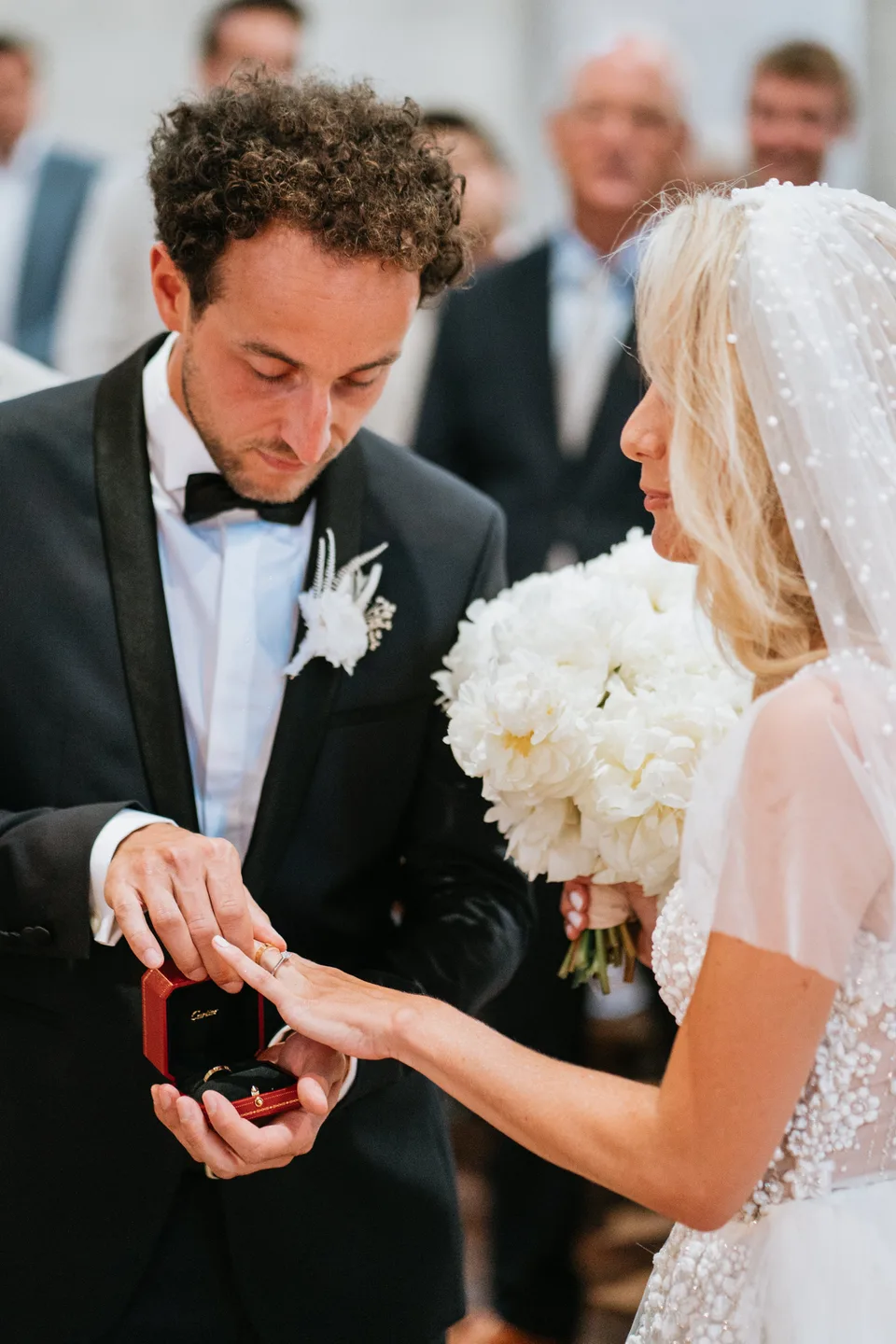 Exchanging wedding rings in front of guests