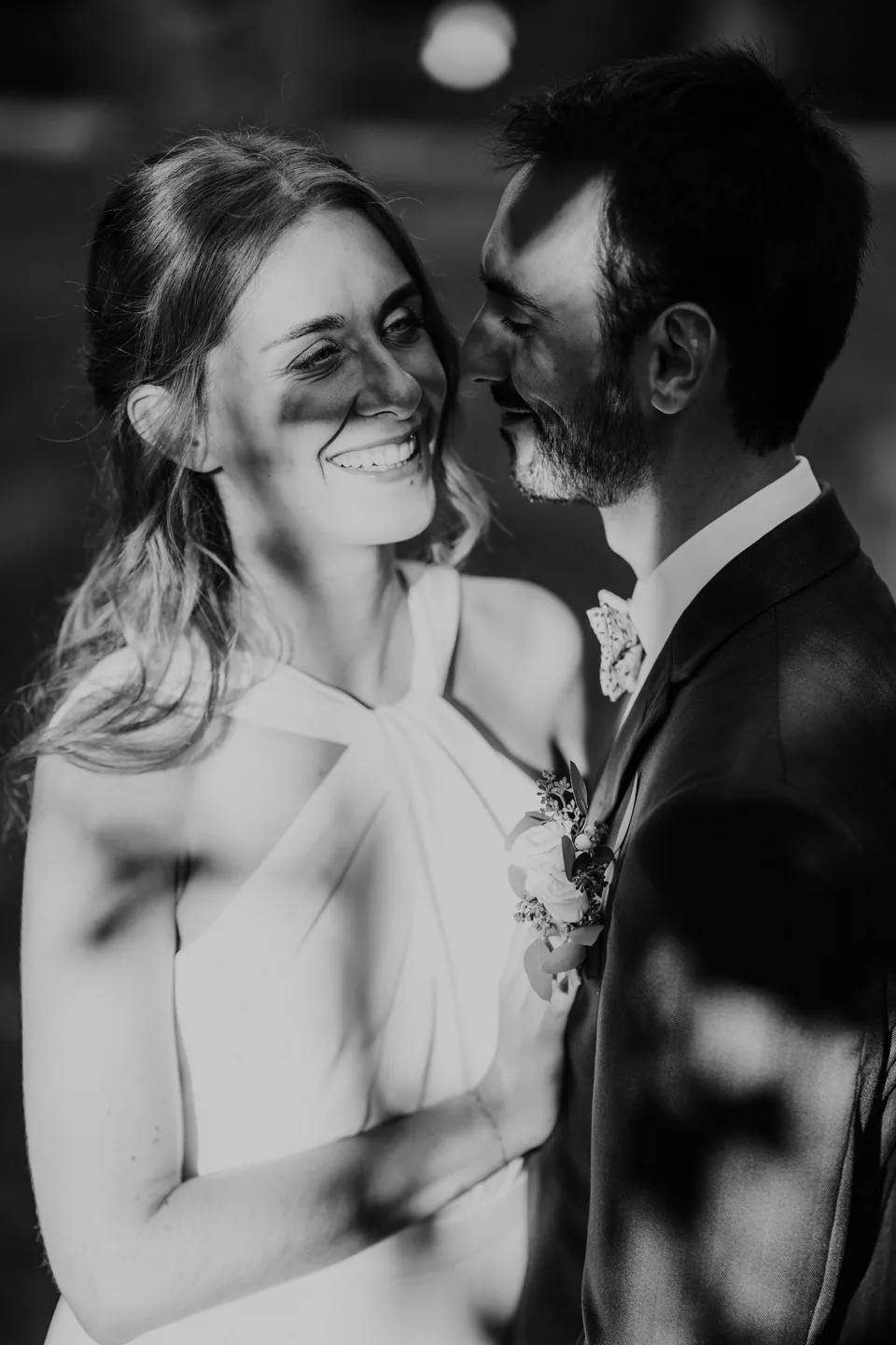 A kiss on the bride’s cheek, in black and white
