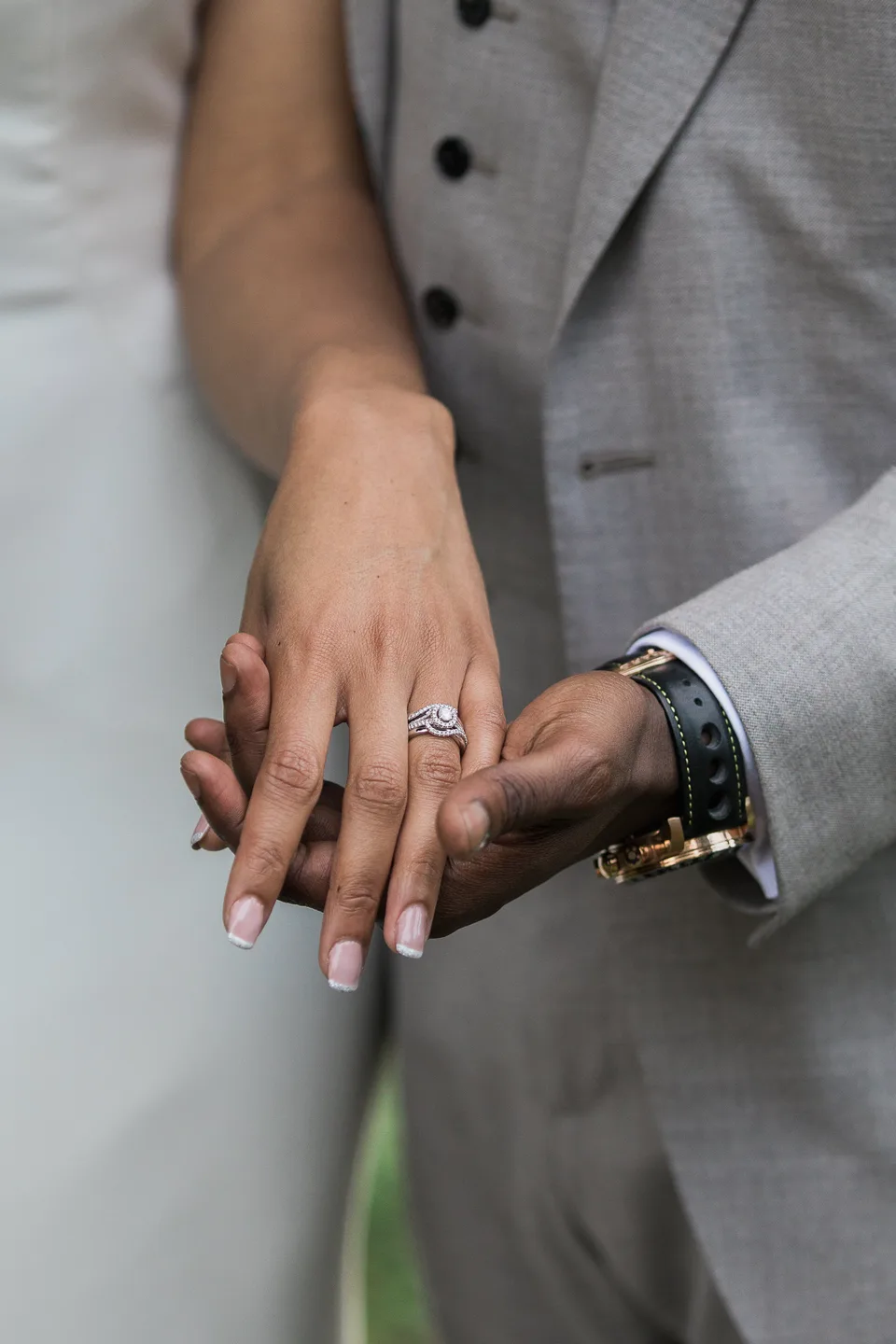 Close-up of the newlyweds’ hands and wedding rings