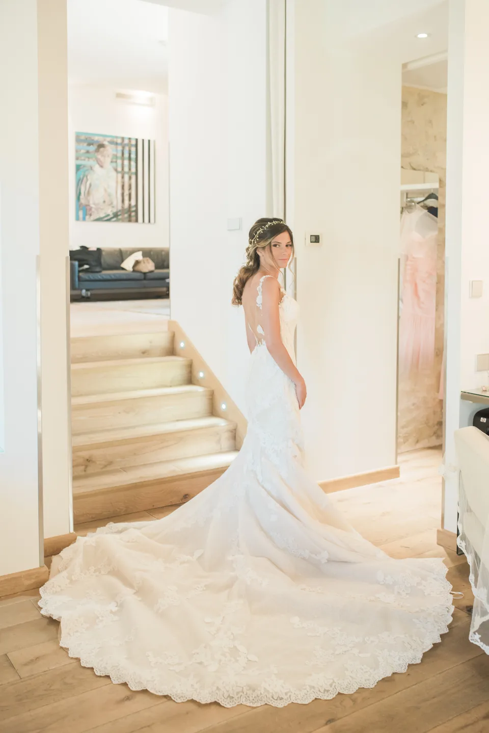 The bride and her dress on a bright staircase