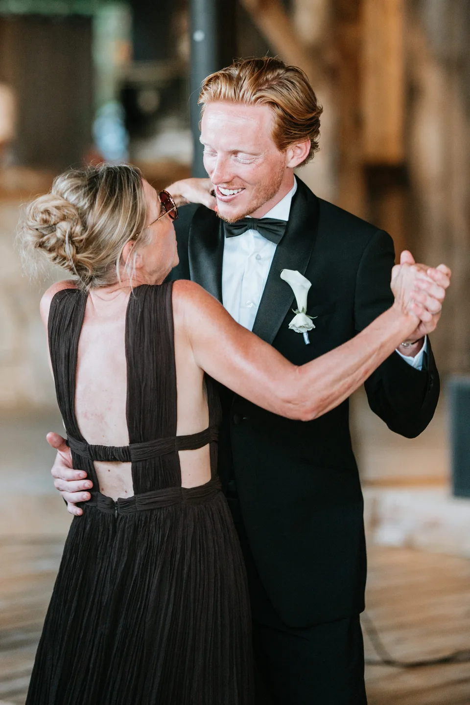 A couple embracing as they dance at the reception