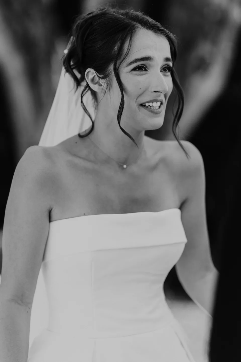 A smiling bridal portrait in black and white