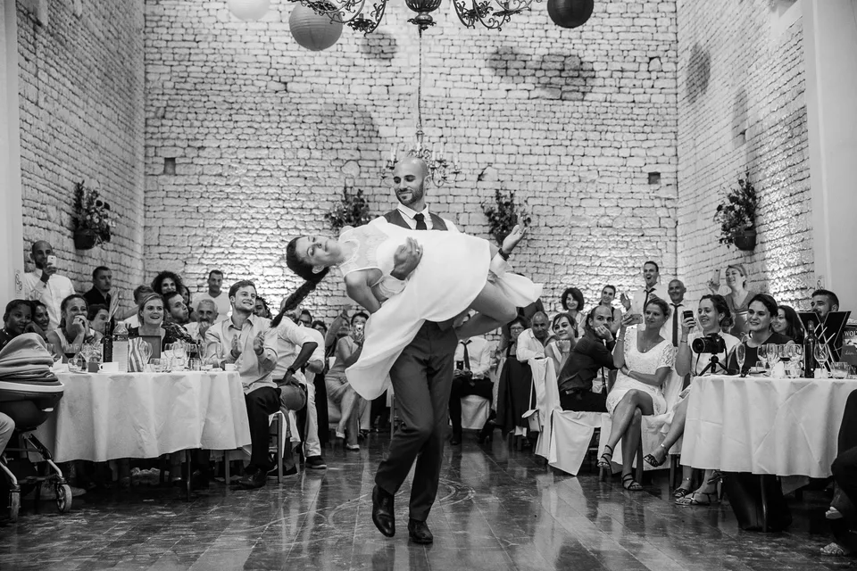 A guest lifted above the dance floor, in black and white