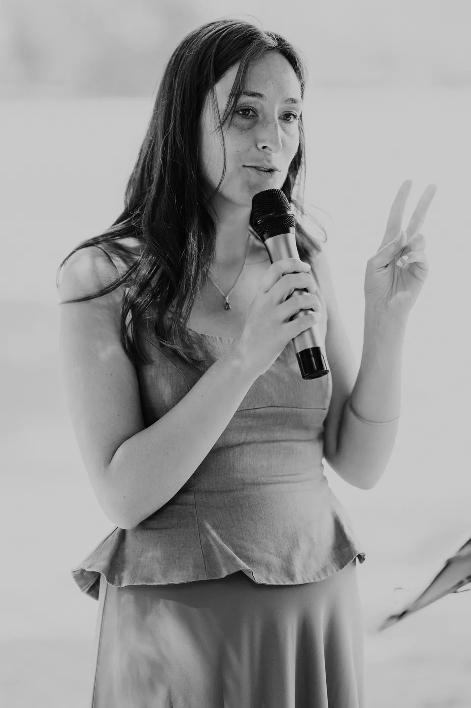 A guest speaking into a microphone, in black and white