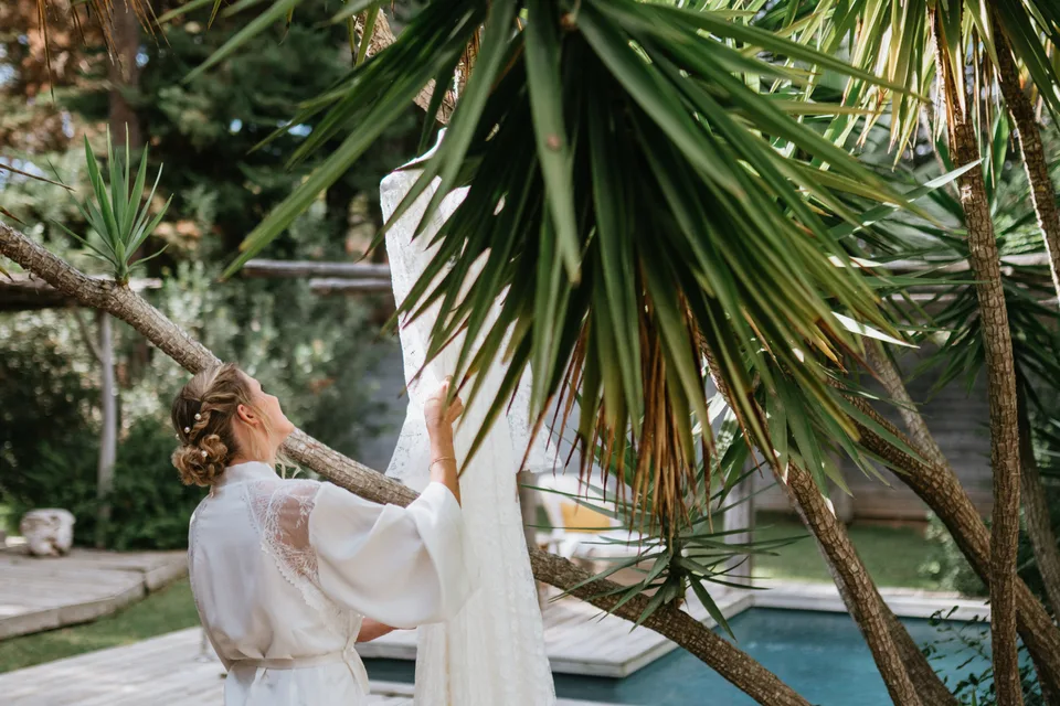 The bride on steps surrounded by palms
