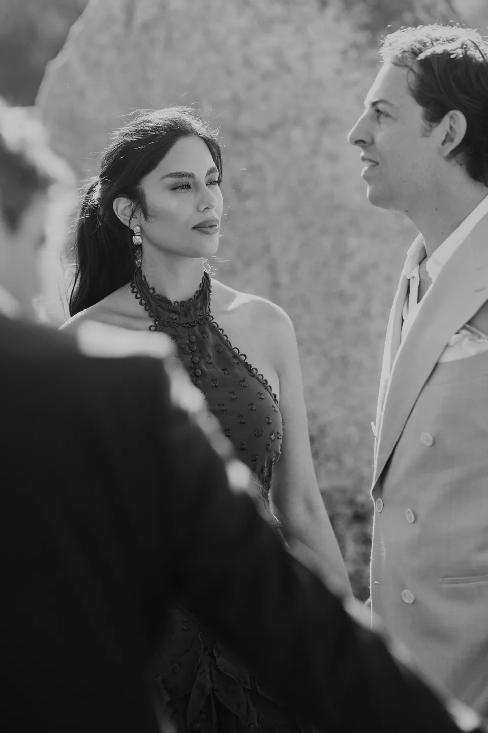 The bride exchanging a glance during the ceremony, in black and white