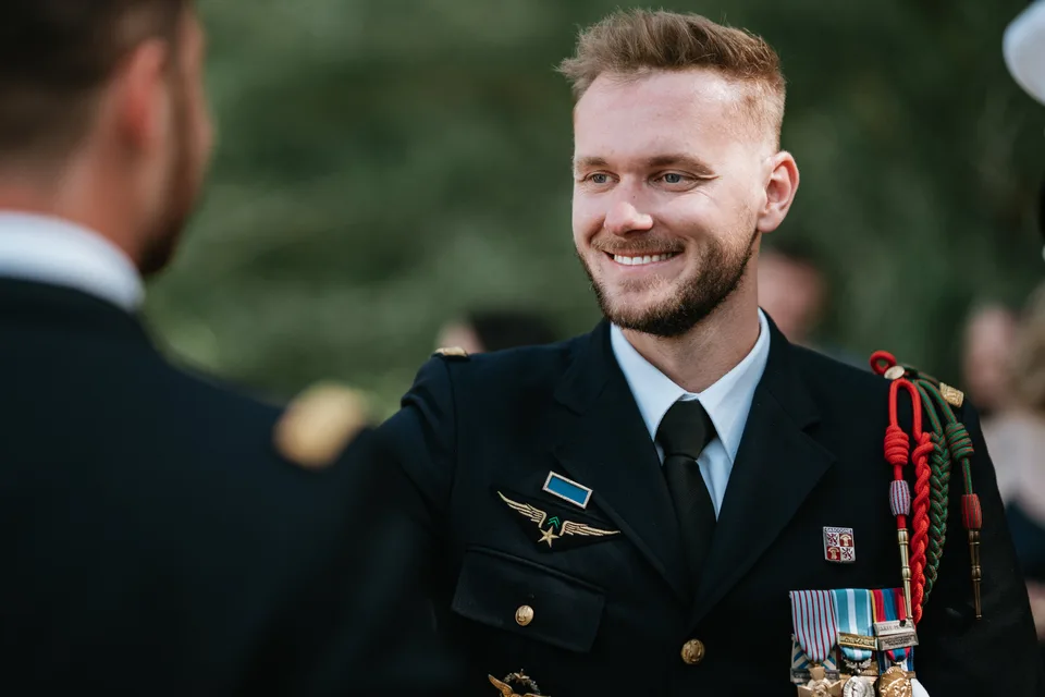 A guest in uniform smiling during the drinks reception